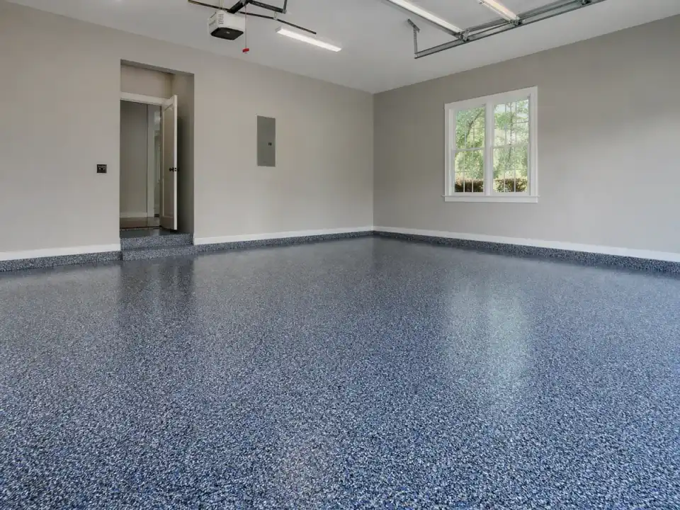 Blue-and-black flake polyaspartic coating on a Marietta garage floor